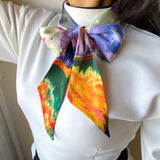 Twilly satin scarf, with pastel impressionist design, worn in a bow design