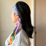 Twilly satin scarf, with pastel impressionist design, worn as a headband