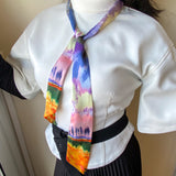 Twilly satin scarf, with pastel impressionist design, worn in a simple knot