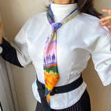 Twilly satin scarf, with pastel impressionist design, worn as a tie
